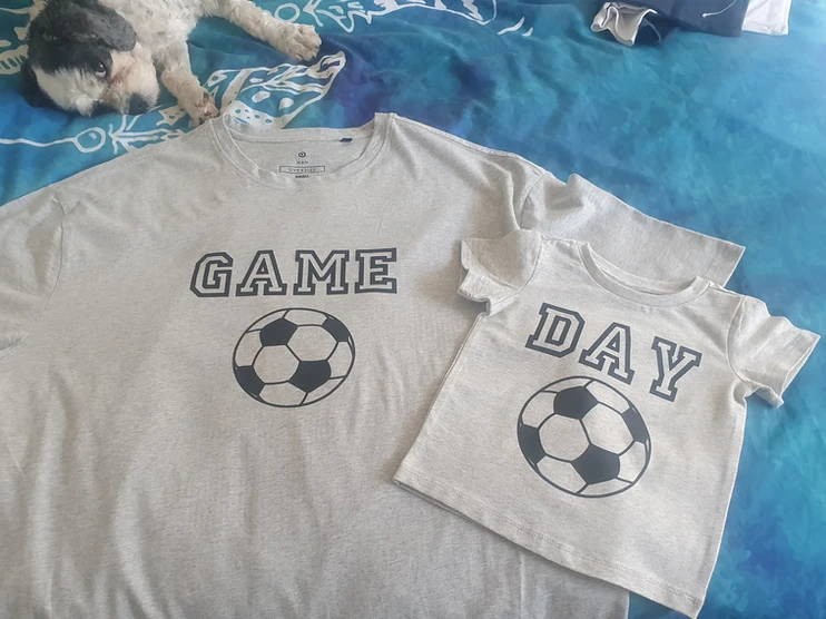 Matching grey adult and child T-shirts with football designs and the words 'Game' and 'Day'