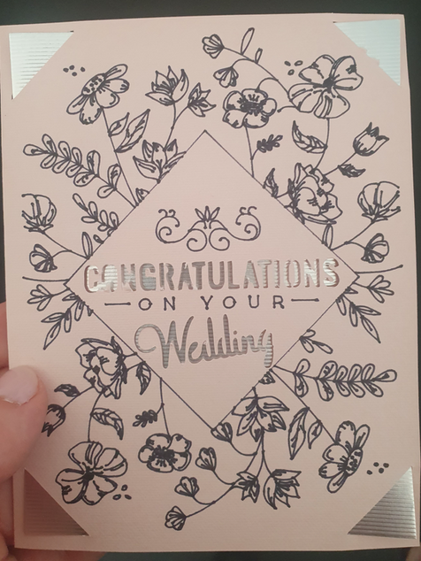 Pink wedding card with floral line drawings and the message 'Congratulations on your Wedding'