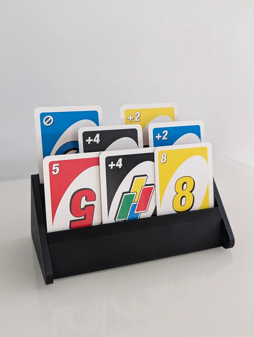 Black tiered playing-card holder displaying UNO cards